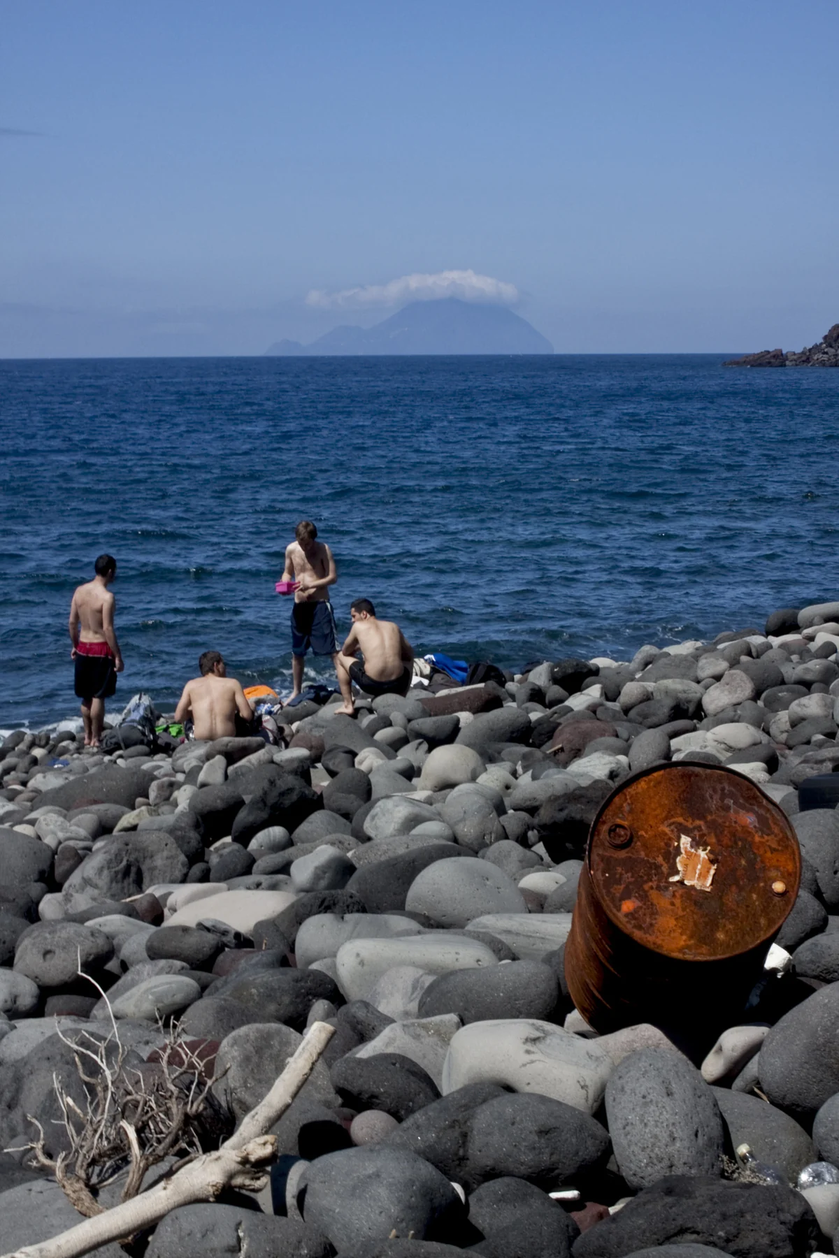 Stromboli village seafront with the volcano rising straight above, Aeolian Islands, Italy